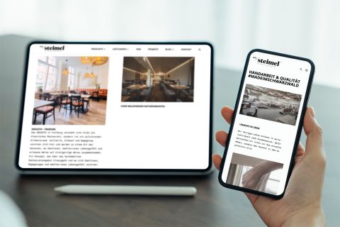 Steimel-Website auf Tablet und Smartphone Tablet und Smartphone zeigen die Website von Steimel, mit Fokus auf hochwertige Möbelprojekte und Handarbeit im Schwarzwald.